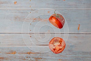 Fresh organic tomato cut in half floating