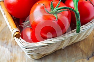 Fresh organic tomatoes in a basket. Close up