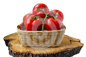 Fresh organic tomatoes in a basket isolated on white.. Close up