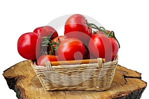 Fresh organic tomatoes in a basket isolated on white.. Close up