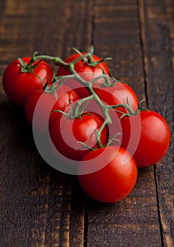 Fresh organic tomatoes on grunge wooden board