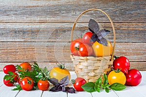 Fresh organic tomatoes in a wicker basket on a wooden table