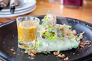 Fresh organic vegetable Thai Fresh spring rolls with sauce in restaurant on wooden background close up. Healthy food