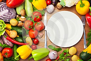 Fresh Organic Vegetables Around White Plate with Knife and Fork