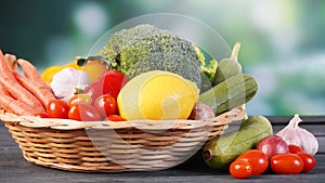 Fresh organic vegetables in basket on table and blur background, Healthy food concept.