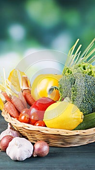 Fresh organic vegetables in basket on table and blur background, Healthy food concept.