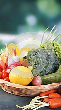 Fresh organic vegetables in basket on table and blur background, Healthy food concept.