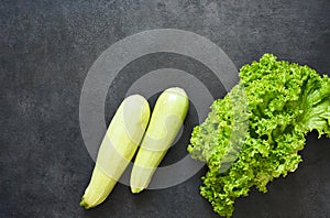 Fresh, organic vegetables on a black stone background. View from above. Bio vegetables