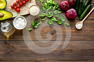 Fresh organic vegetables on dark wooden background top view copy space. Kitchen desk for preparing salad