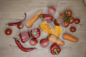 Fresh organic vegetables in red color on a wooden table