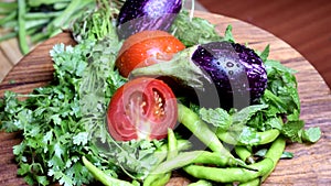 Fresh Organic Vegetables rotating on Wooden Chopper Board Surface