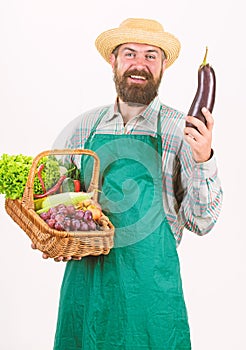 Fresh organic vegetables wicker basket. Man bearded presenting vegetables white background isolated. Hipster gardener