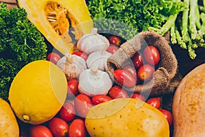 Fresh organic vegetables on wood background for cooking salad. Diet and healthy food. Fall harvest cornucopia