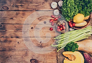 Fresh organic vegetables on wood backgroundfor cooking salad. Diet and healthy food. Fall harvest cornucopia