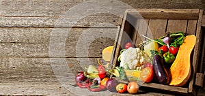 Fresh organic vegetables in wood crates on wooden floor with copy space. concept vegetables fresh from the farm.