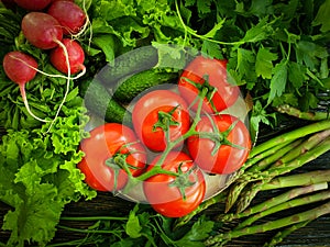 Fresh organic vegetables on a wooden background, tomato