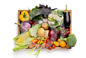 Fresh organic vegetables in wooden box on white