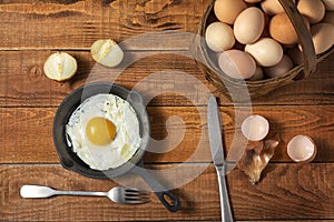 Fresh organic village eggs on wooden table, healthy food,  village food. black pan with fried egg.