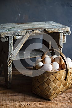Fresh organic village eggs on wooden table, healthy food,  village food. black pan with fried egg. small bench background