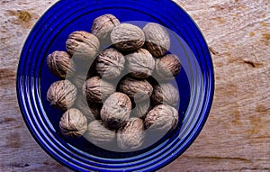 Fresh Organic walnuts in a blue bowl