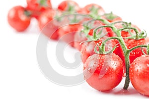 Fresh organic wet cherry tomatoes bunch closeup isolated on white background