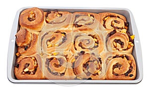 Fresh from the oven chelsea buns in a baking tin - viewed from a