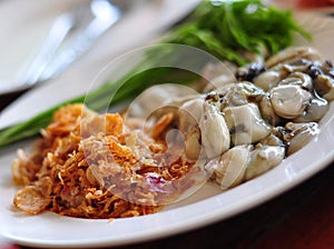 Fresh oyster served with garlic and vegetables