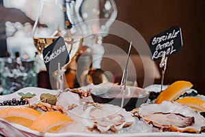 Fresh Oysters close up on a plate, served table with oysters, lemon and ice. Healthy sea food.