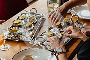 Fresh oysters with lemon. raw opened oyster, lifestyle food, ready to eat. Oyster dinner with champagne in restaurant