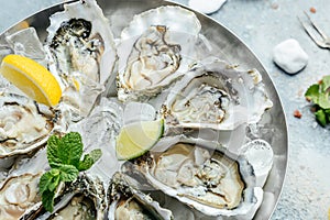 Fresh Oysters with lime, lemon and ice. Restaurant menu, dieting, cookbook recipe