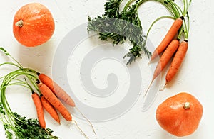 Fresh pampkin and carrot on white vintage background.