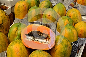 Fresh papaya fruit symmetrically to attract buyers at market stall photo