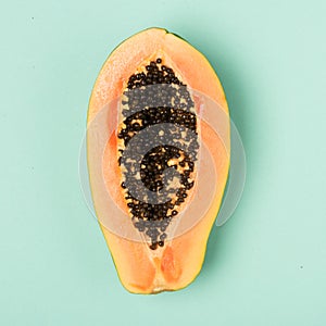 Fresh papaya  on mint background. Flat lay style.