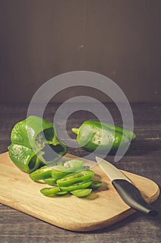 fresh paprika cut on a wooden board/ fresh paprika cut on a wooden board on a dark background with copy space