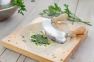 Fresh parsley on a board with mezzaluna photo