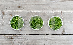 ??fresh parsley, chives and spring onion on a light wooden background