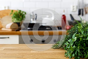 Fresh parsley and dill on wood counter with space for text. Out