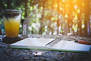 Fresh passion fruit juice in glass on table with is tree garden background