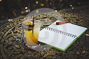 Fresh passion fruit juice in glass on table with is tree garden background.