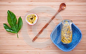 Fresh passion fruits juice in bottle on bamboo background. Juic