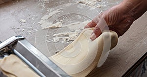 Fresh pasta maker machine. Dough homemade preparation. Hand make dough phylo close up view