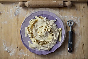 fresh pasta, rolling pin and metal cutting wheel