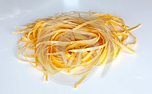 Fresh pasta shaped as tagliatelle drying