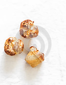 Fresh pastries - brioche buns on a light background, top view