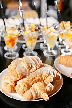 Fresh pastry, crispy morning croissants, hotel breakfast buffet. Dessert fruit cocktail in cups