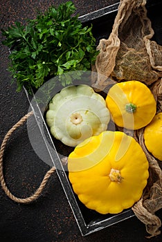 Fresh patissons in wooden box