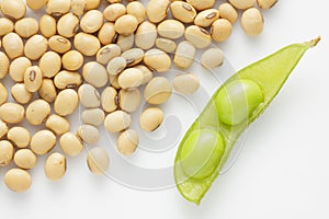 Fresh pea pod and dry soybean on white background.