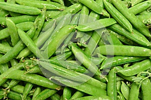 Fresh pea pods as background. Top view