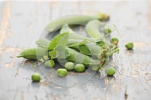 Fresh pea pods on a background of colored boards