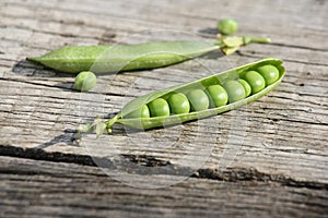 Fresh pea pods onwooden boards